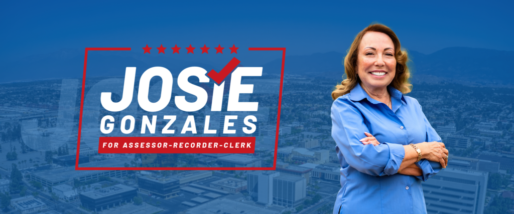 A smiling person with arms crossed stands in front of a cityscape background. Beside them, the text reads: "Josie Gonzales for Assessor-Recorder-Clerk," with stars and a checkmark incorporated into the design.